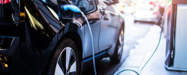 Charging,Modern,Electric,Car,On,The,Street,Which,Are,The